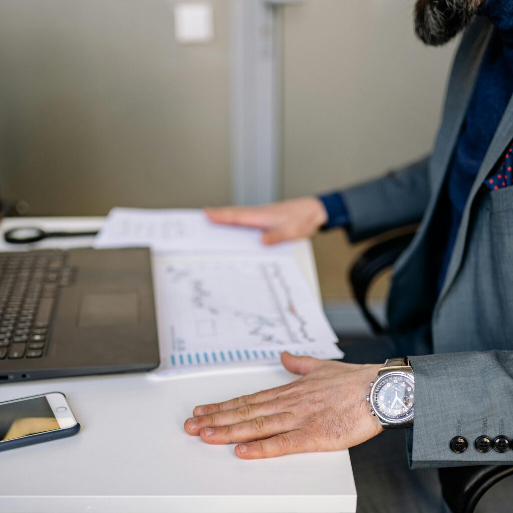 pexels-photo-7793675-7793675 A Person's Hands on His Desk